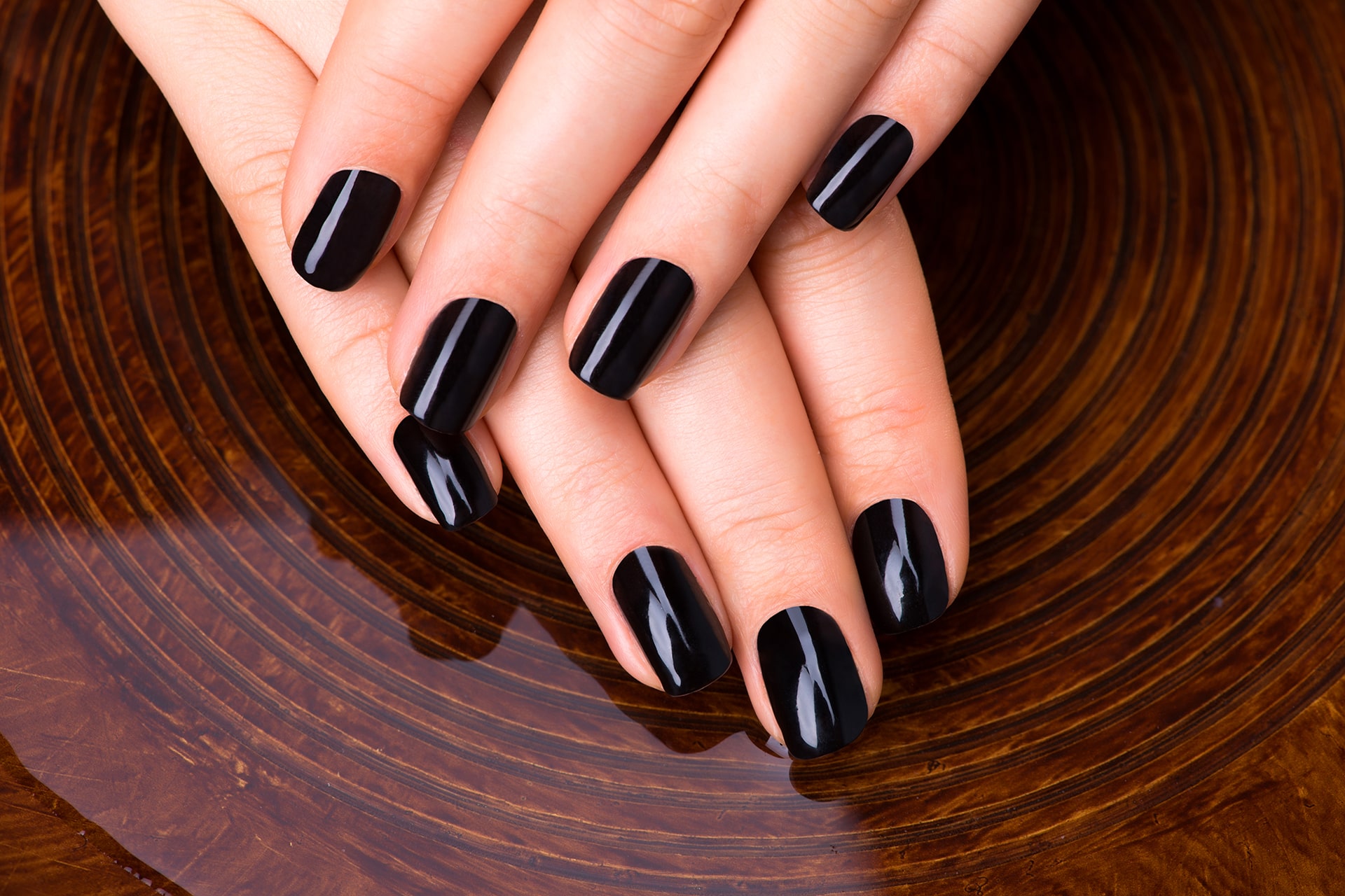 beautiful-women-hands-with-black-manicure-after-spa-procedures-spa-treatment-concept