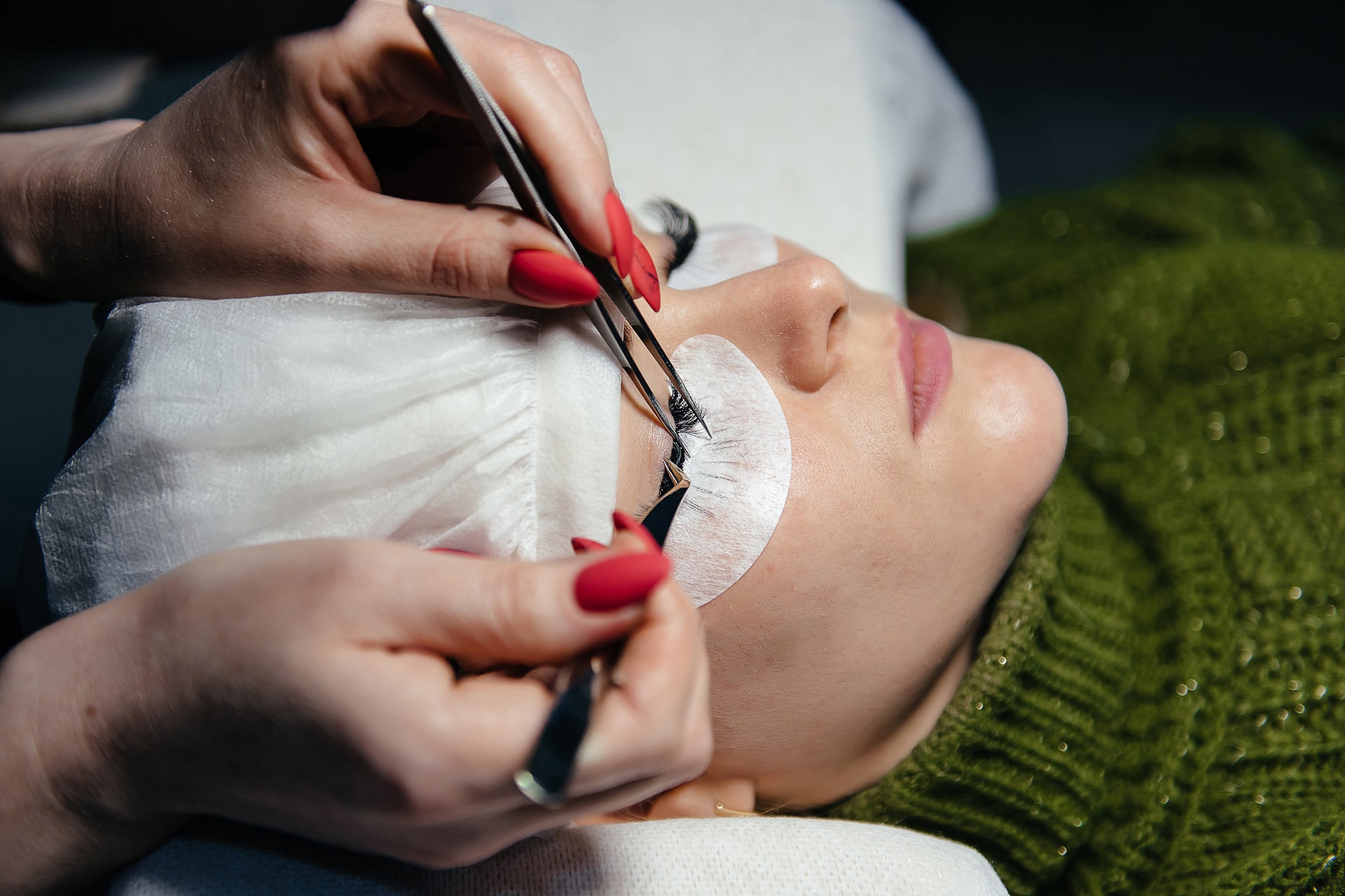 eyelash-extension-process-closeup-portrait-young-girl-woman-with-long-thick-eyelashes-eyes-closed-hand-cosmetologist-adding-more-eyelashes-her